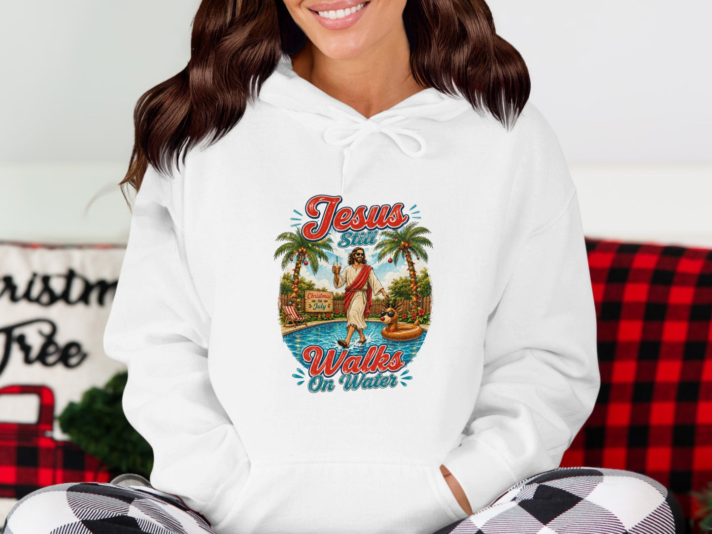 Hoodie with "Jesus Still Walks On Water" graphic and tropical scene.
