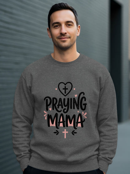 Man wearing gray sweatshirt with "Praying Mama" text and cross graphics.