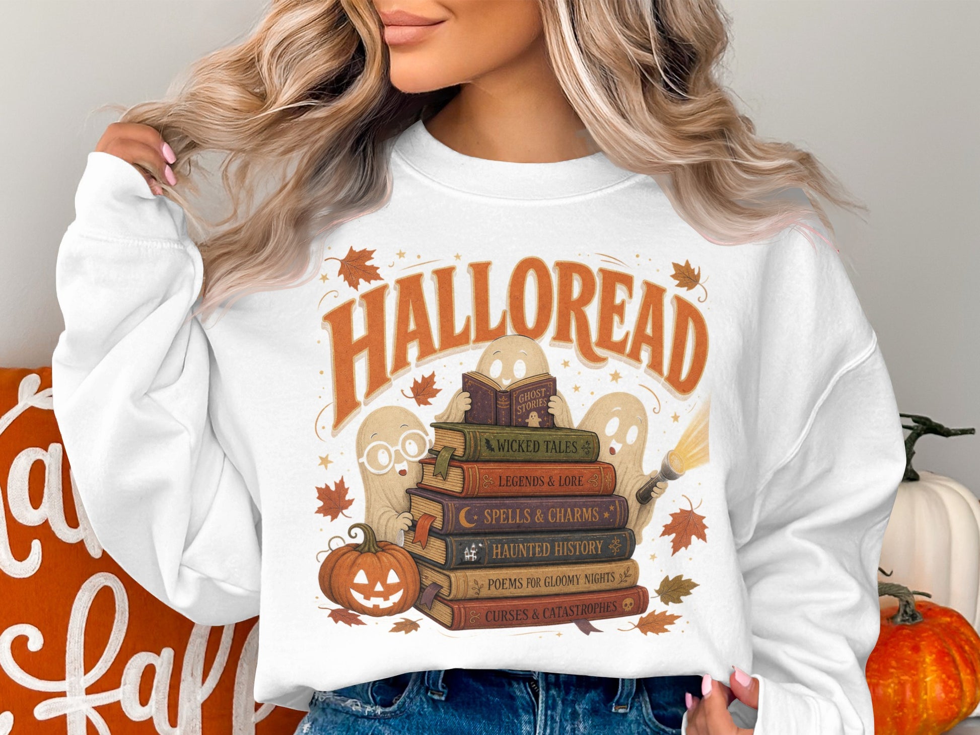 White sweatshirt with "Halloread" text, ghosts, and stacked Halloween books.