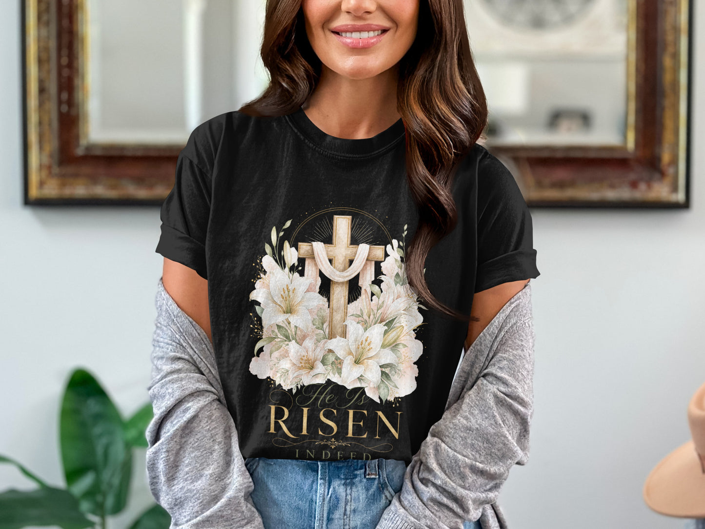 Black t-shirt with gold cross, lilies, and text "He Is RISEN Indeed".