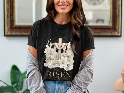 Black t-shirt with gold cross, lilies, and text "He Is RISEN Indeed".