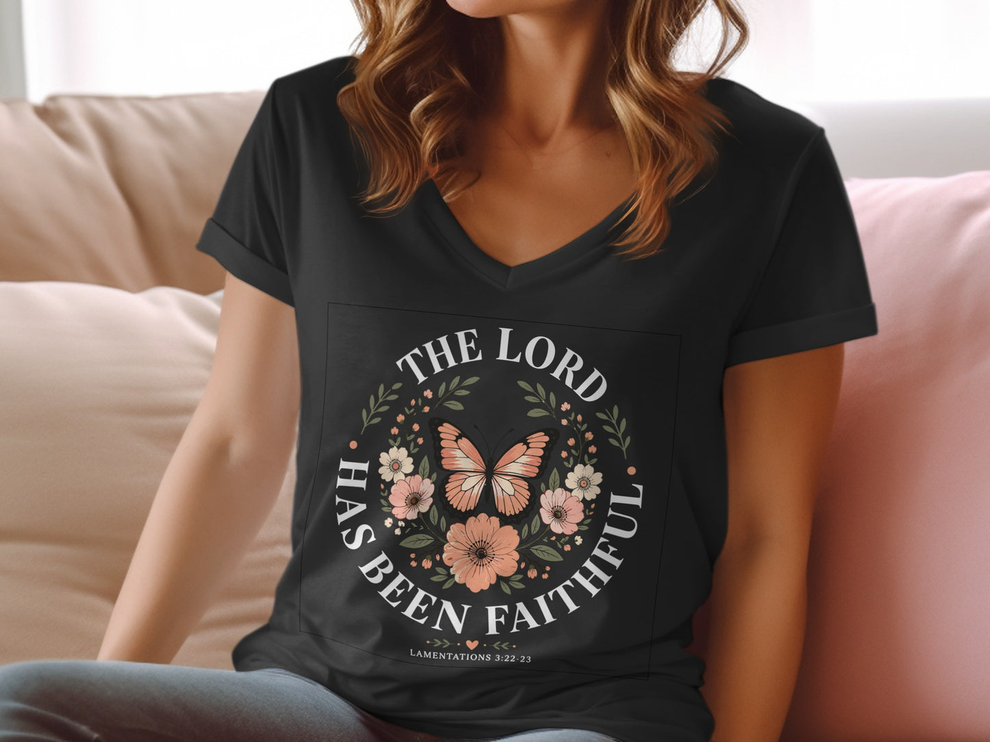 Black v-neck t-shirt with "The Lord Has Been Faithful" text and floral butterfly design.