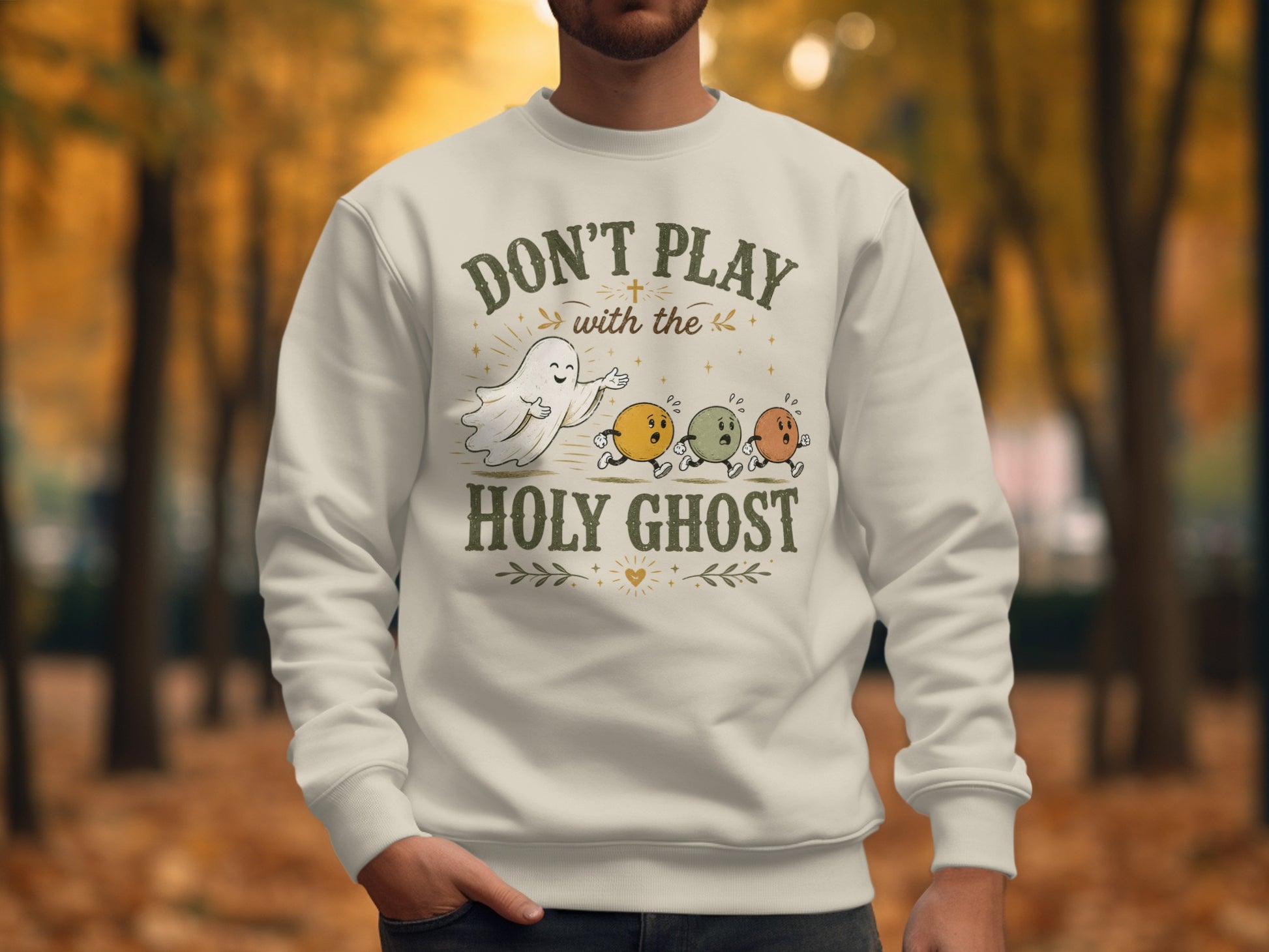 Crewneck sweatshirt with "Don't Play With The Holy Ghost" text and cartoon ghost chasing eyeballs.