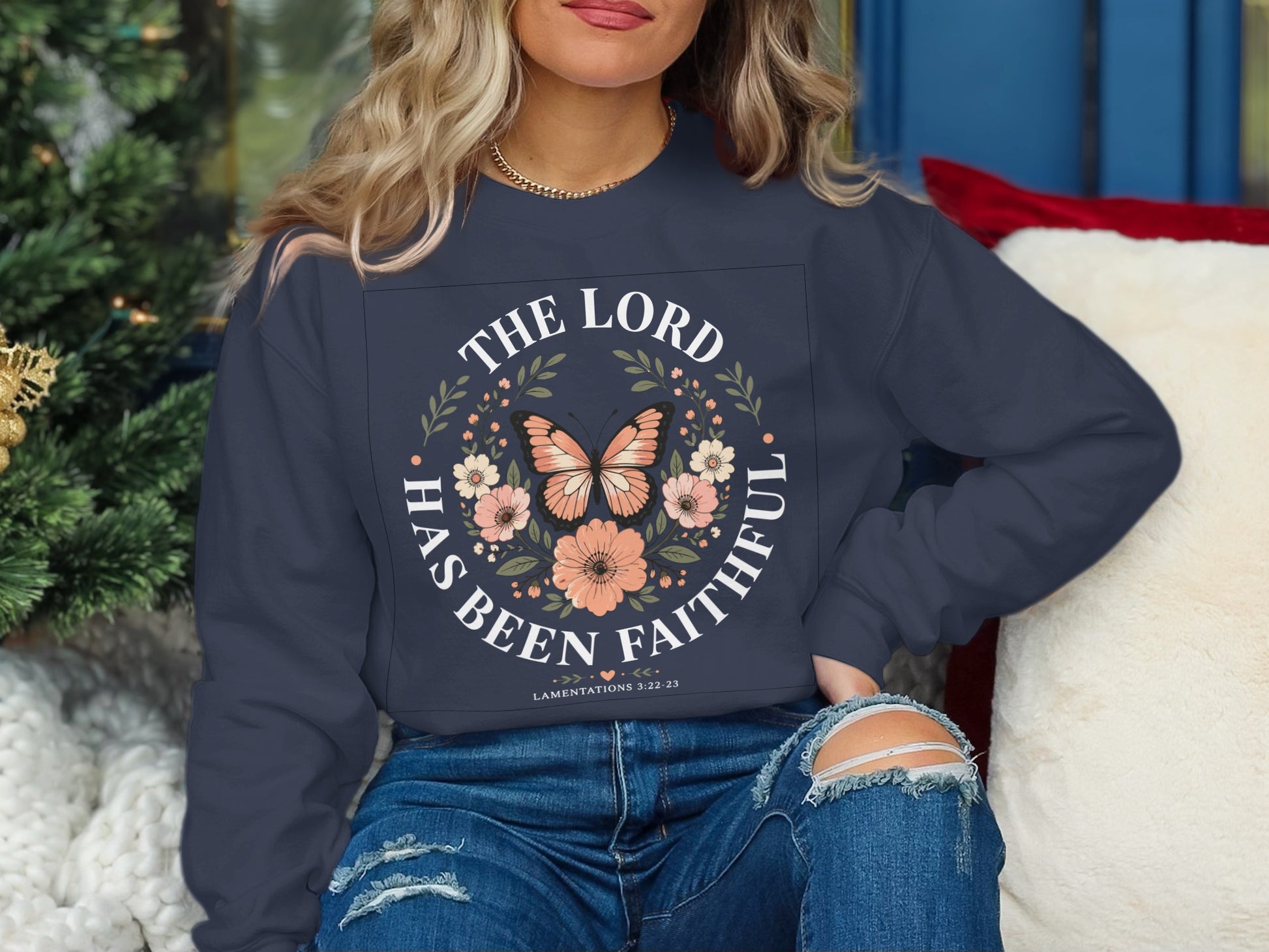 Navy sweatshirt with "The Lord Has Been Faithful" and floral butterfly design.