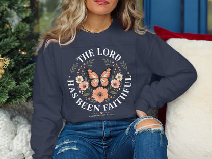 Navy sweatshirt with "The Lord Has Been Faithful" and floral butterfly design.