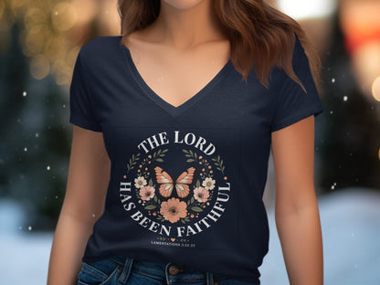 Navy v-neck t-shirt with floral wreath and butterfly, "The Lord Has Been Faithful" scripture.