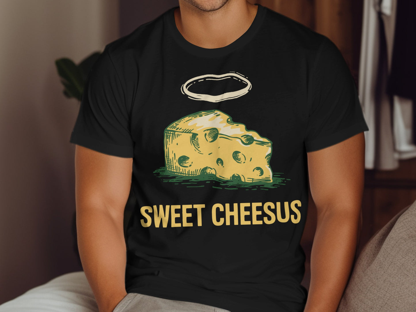 Black t-shirt with "Sweet Cheesus" text and a wedge of cheese with a halo.