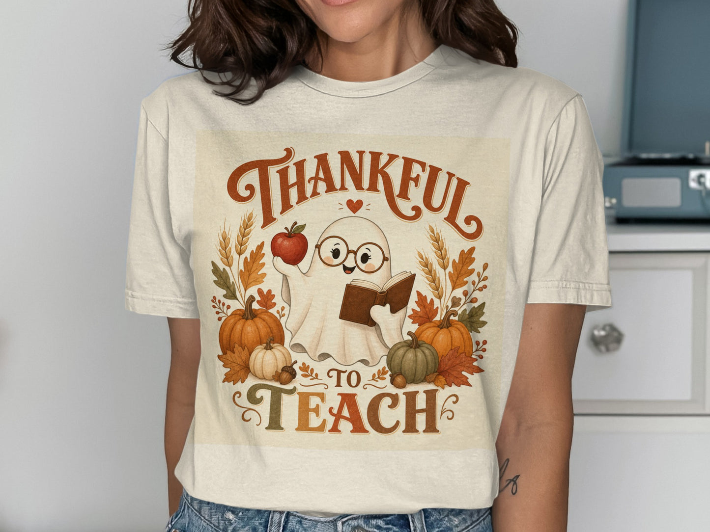 Ghost in glasses holding apple and book, "Thankful to Teach" text.