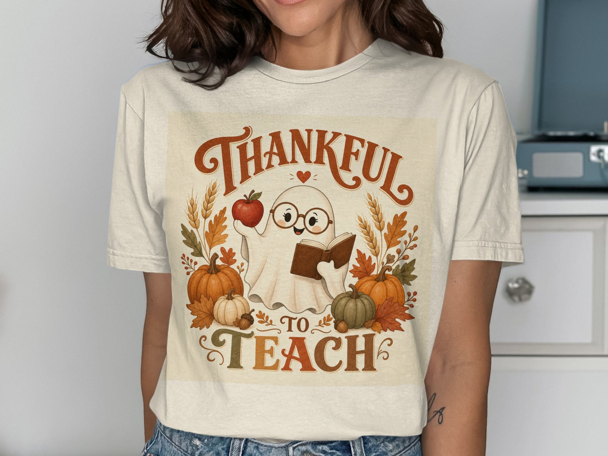 Ghost in glasses holding apple and book, "Thankful to Teach" text.