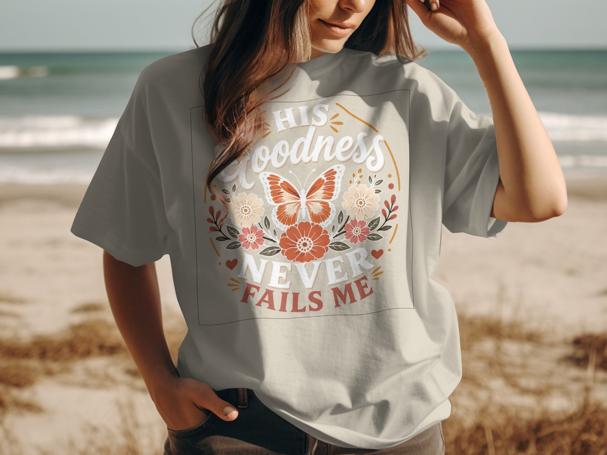 T-shirt with "His Goodness Never Fails Me" text and floral butterfly design.