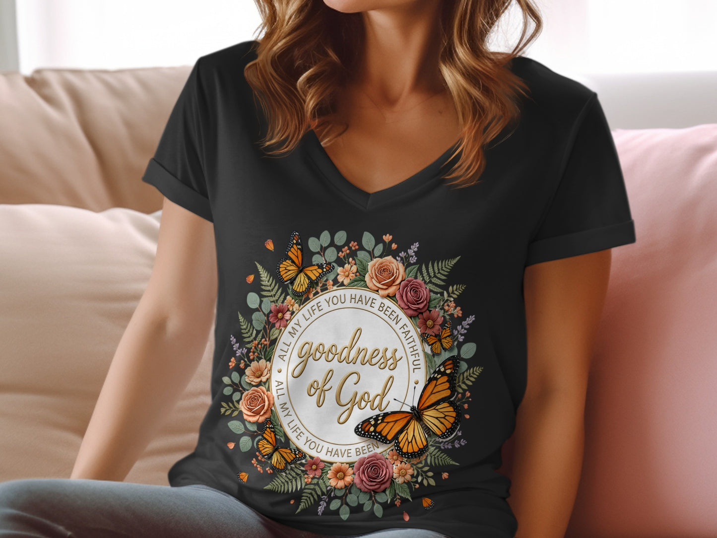 Black v-neck t-shirt with floral wreath and "goodness of God" text.