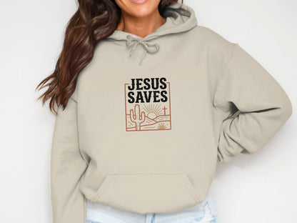 Beige hoodie with "Jesus Saves" text and desert landscape graphic.