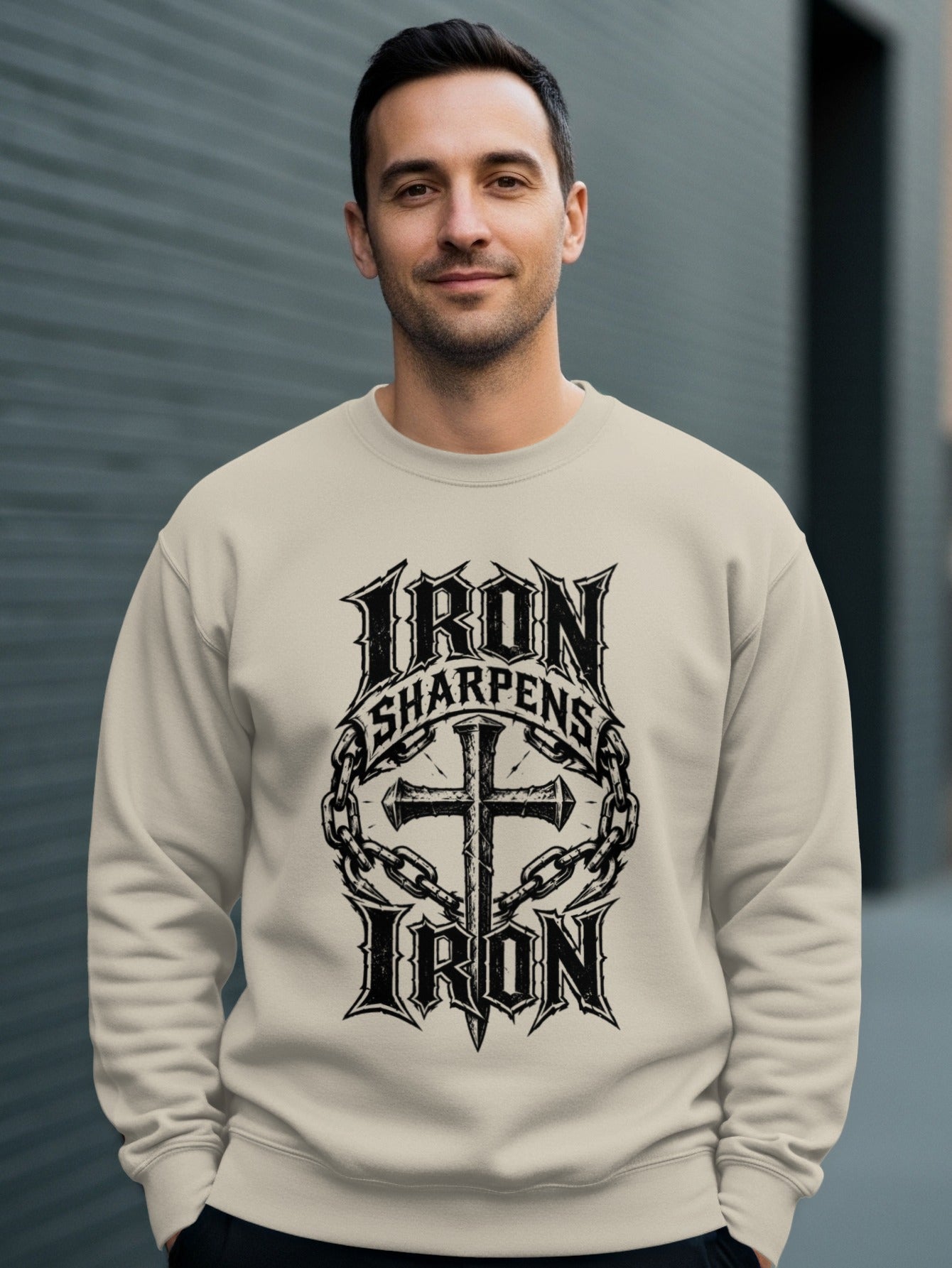 Cream sweatshirt with "Iron Sharpens Iron" and cross graphic.