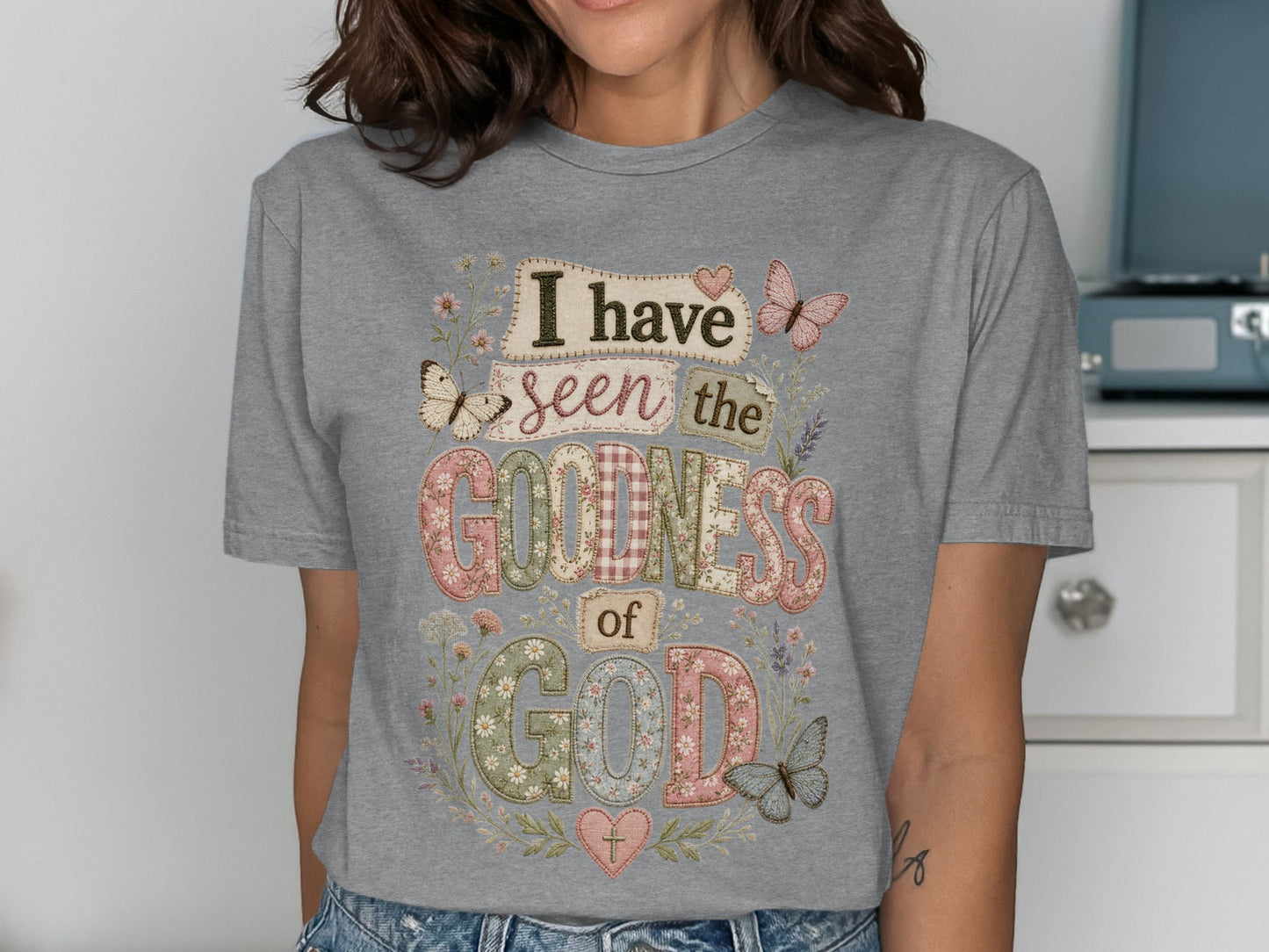 Gray t-shirt with "I have seen the goodness of God" in colorful, patterned letters.