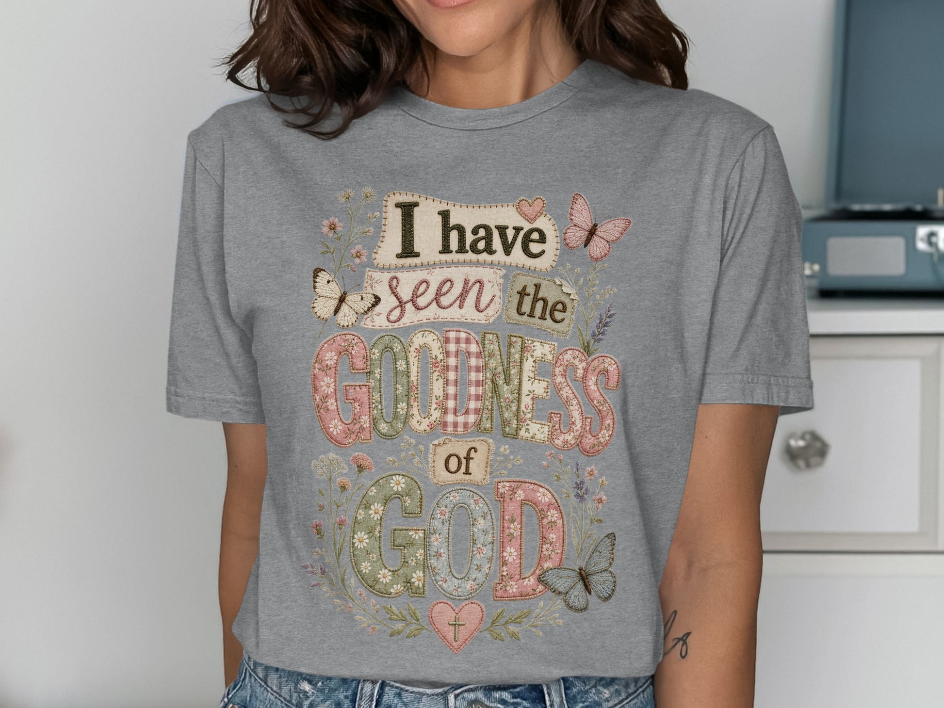 Gray t-shirt with "I have seen the goodness of God" in colorful, patterned letters.