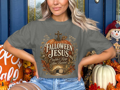"Hallowen Jesus Couldn't Keep Him Buried" graphic on a grey t-shirt.