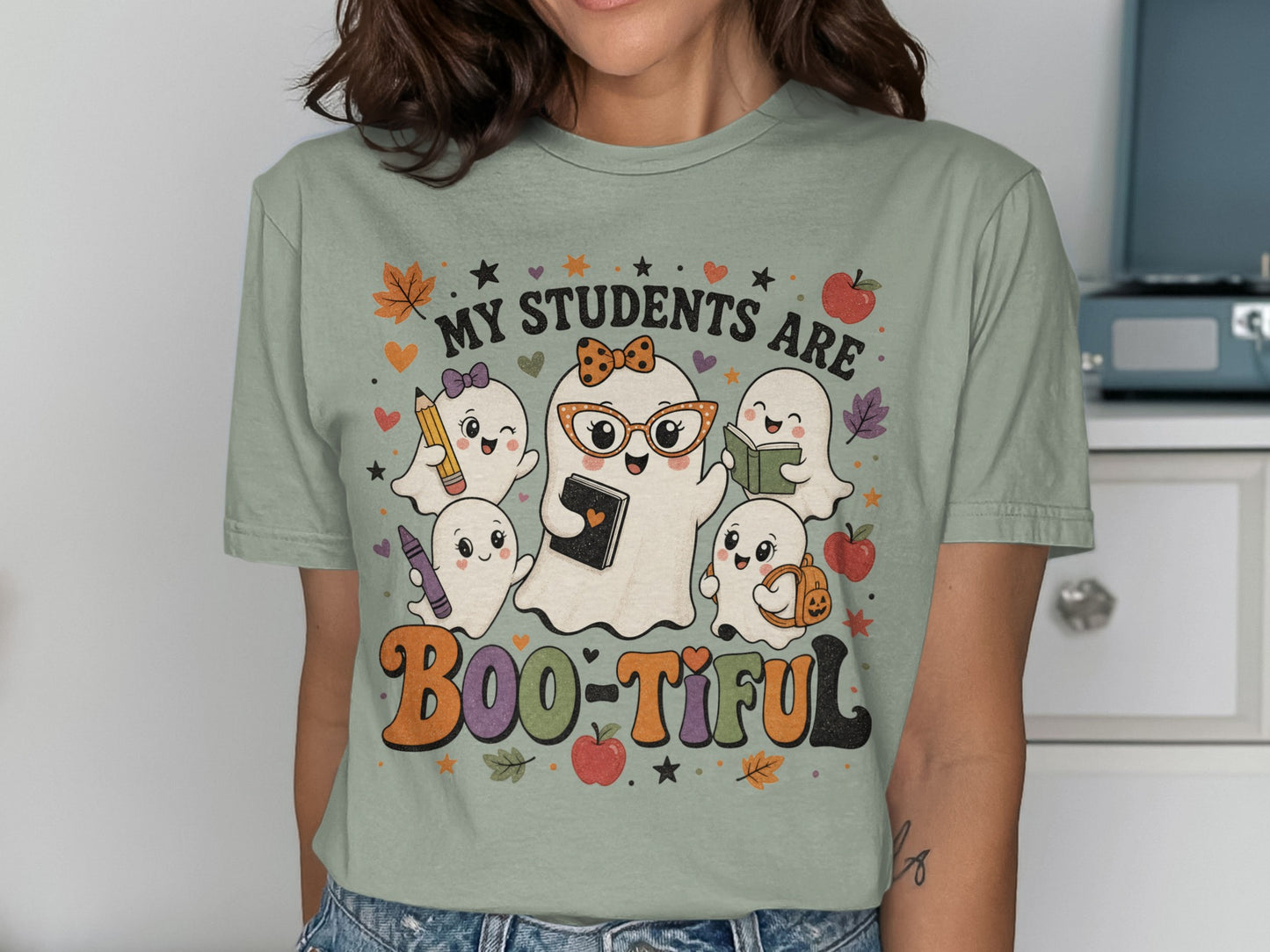 "My students are Boo-tiful" text with cute ghosts holding school supplies and wearing a bow.