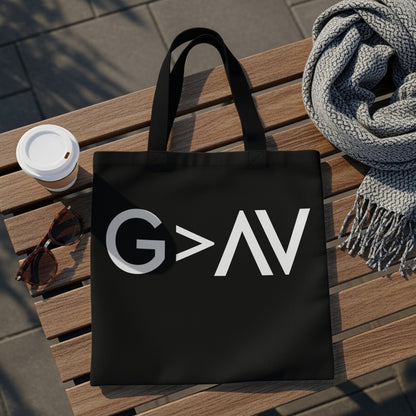 Black tote bag with white "G>AV" text, sunglasses, coffee, and scarf on bench.