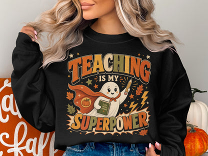 Black sweatshirt with "Teaching Is My Superpower" text and a ghost superhero.