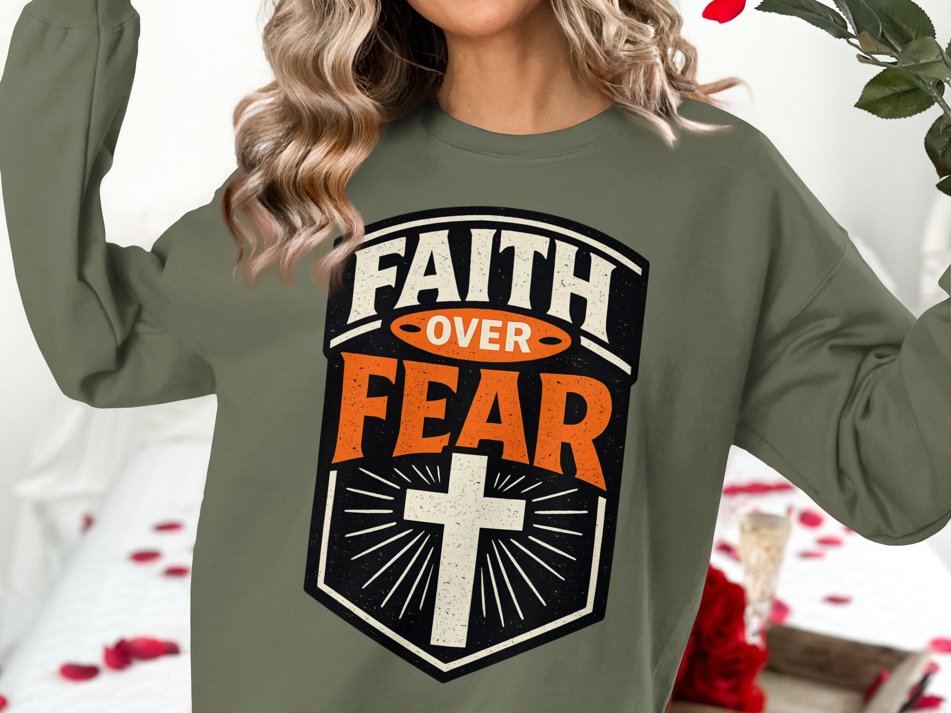 Olive sweatshirt with "Faith Over Fear" text and a cross graphic.