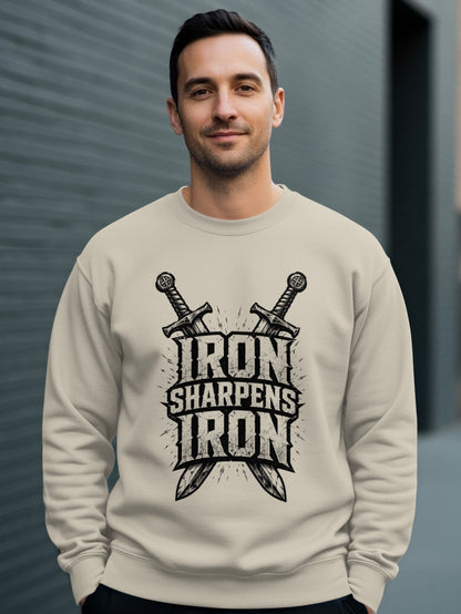 Man wearing a beige sweatshirt with "Iron Sharpens Iron" logo and crossed swords.