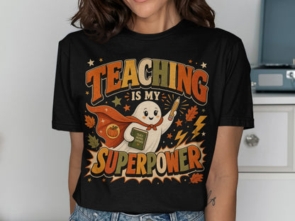 T-shirt with a retro ghost holding a book and pencil, text reads "Teaching Is My Superpower."