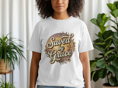White t-shirt with "Saved by Grace" text, a cross, and floral embellishments.