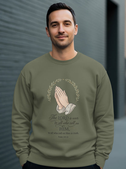 Olive sweatshirt with praying hands and Psalm 145:18 text.