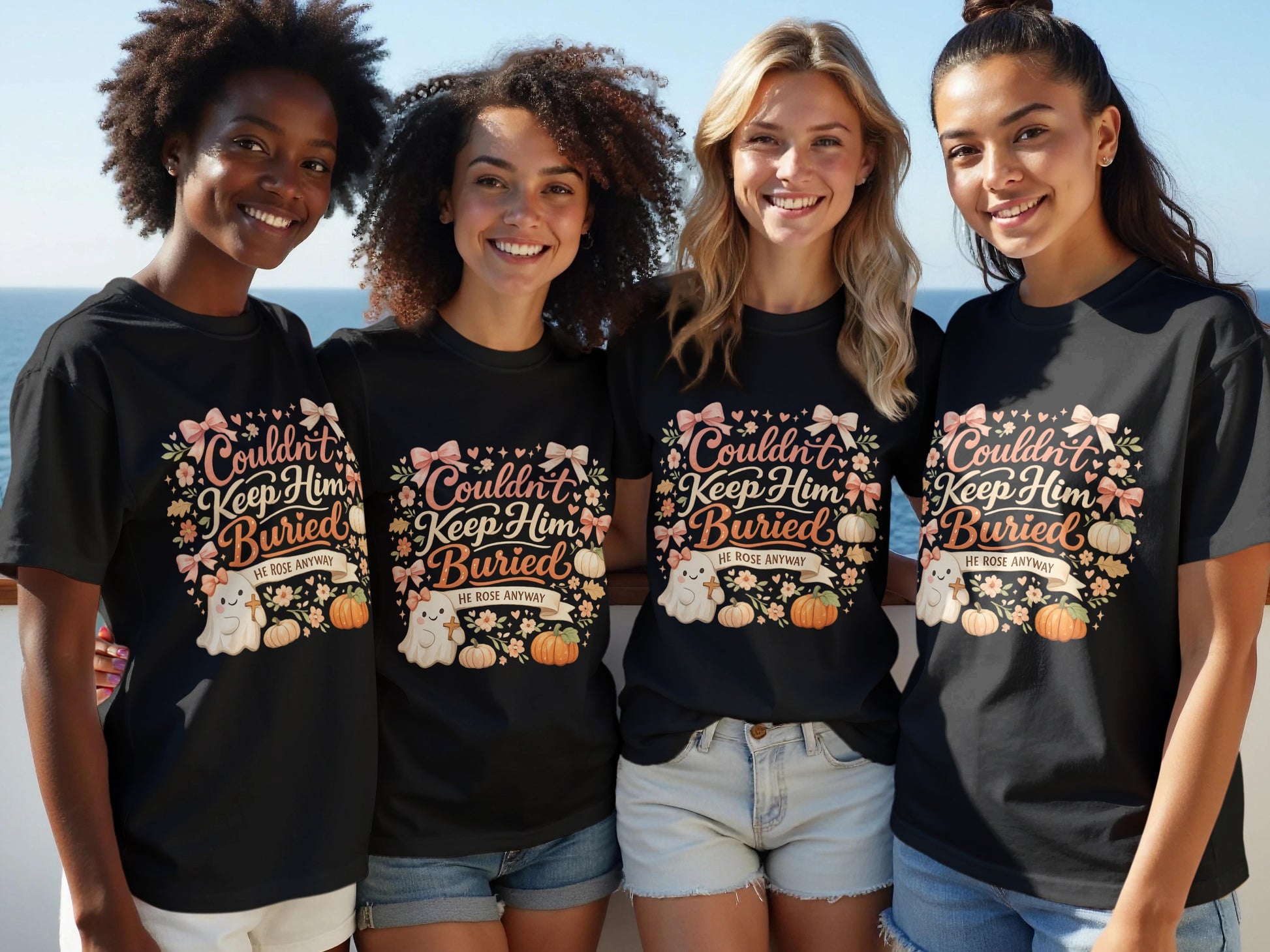 Four women smile wearing black t-shirts with a "Couldn't Keep Him Buried" ghost design.