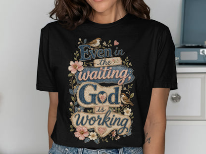 Black t-shirt with "Even in the waiting God is working" text and floral accents.