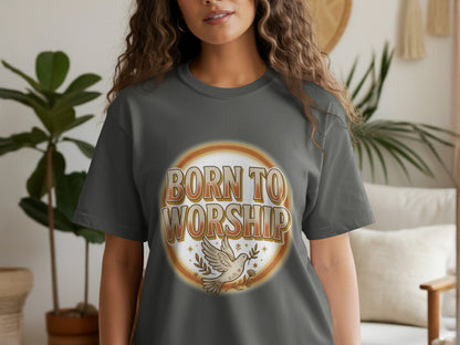 A woman wears a dark grey t-shirt with the text "BORN TO WORSHIP" and a dove.