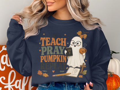 Navy sweatshirt with "Teach Pray Pumpkin Repeat" text and a ghost holding a Bible and coffee.