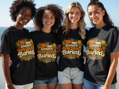 Four women in black t-shirts with "Couldn't Keep Him Buried" autumn graphic.