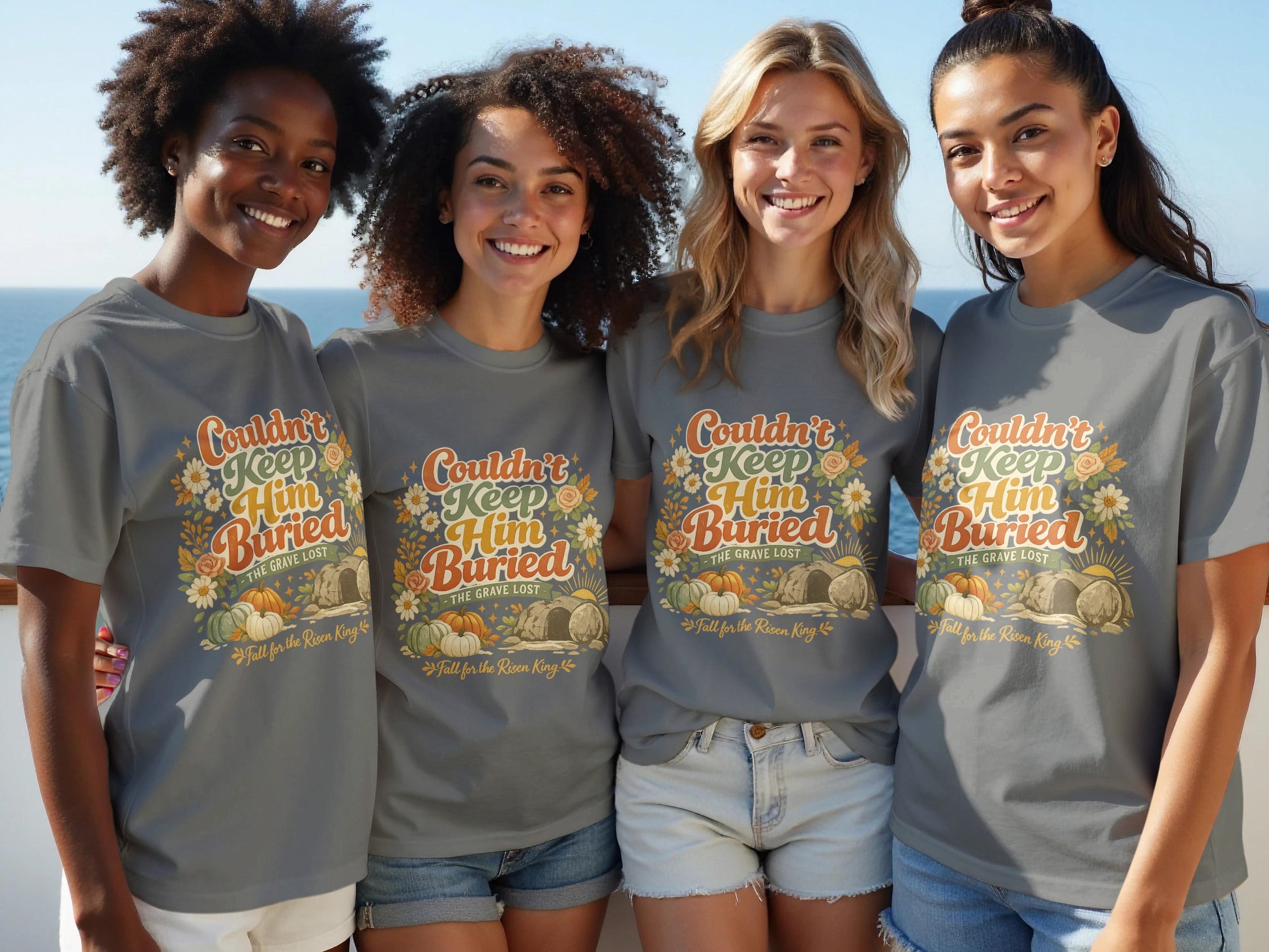 Four women wear grey t-shirts with the text "Couldn't Keep Him Buried" and fall imagery.