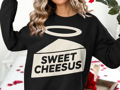 Black sweatshirt with "SWEET CHEESUS" text and halo above cheese slice graphic.