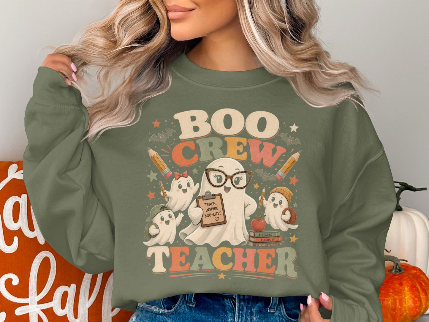 Retro "Boo Crew Teacher" graphic with ghosts, pencils, and books on a green sweatshirt.