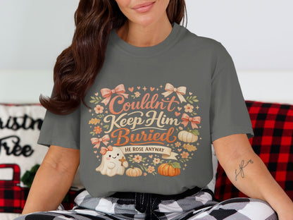 Gray t-shirt with a graphic reading "Couldn't Keep Him Buried. He Rose Anyway."