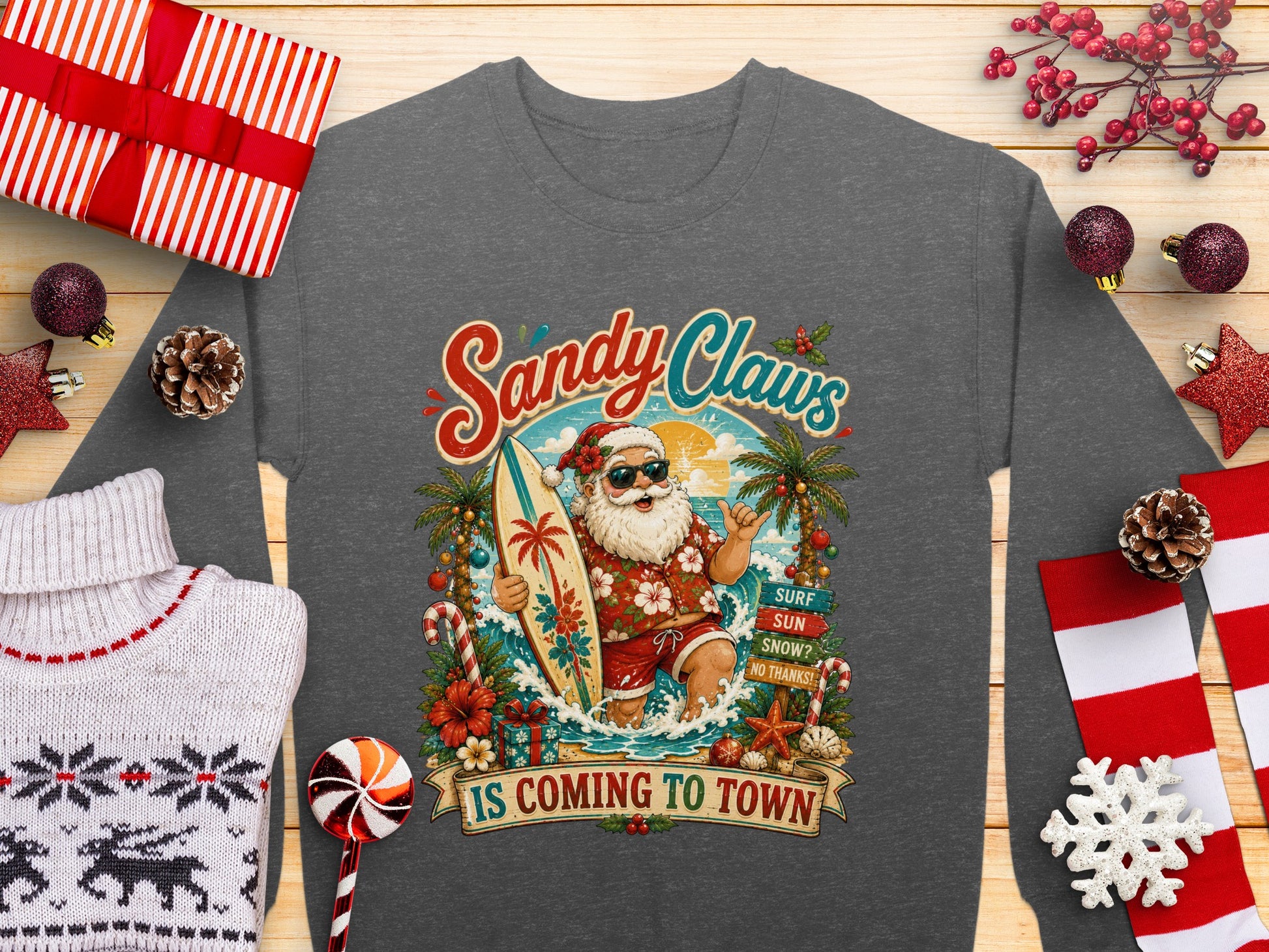 Santa Claus on surfboard with "Sandy Claws Is Coming To Town" text.
