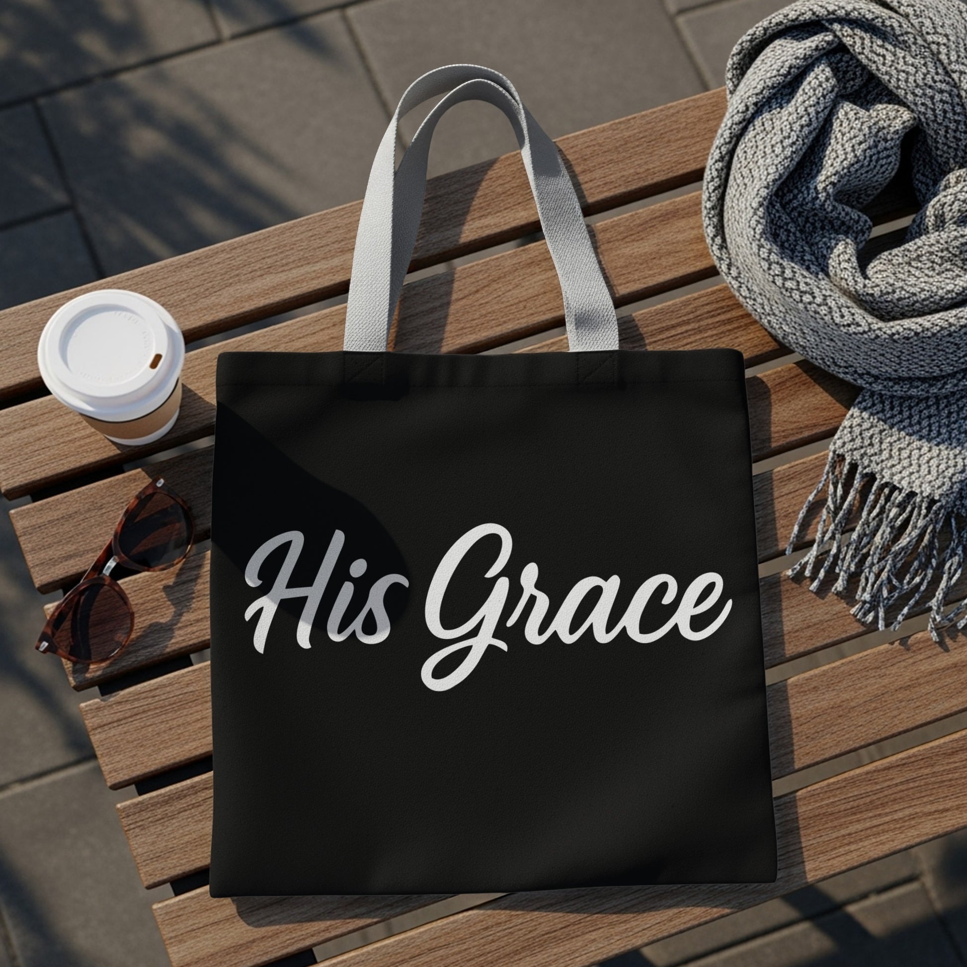 Black tote bag with white script text "His Grace".