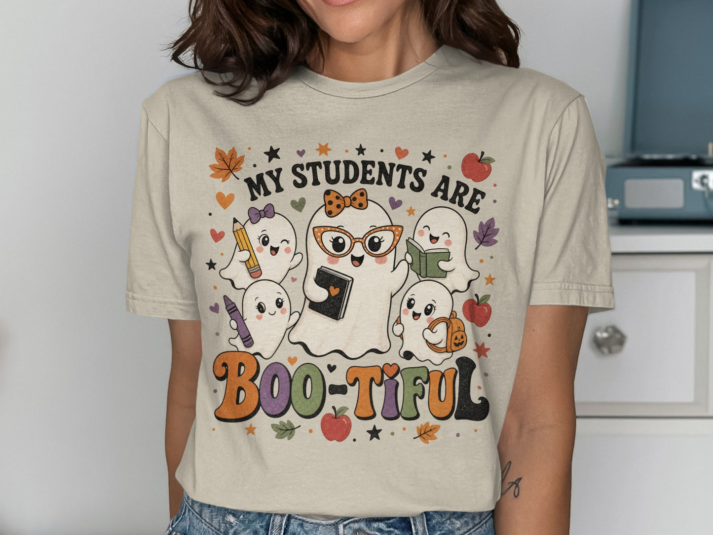 "My Students Are Boo-tiful" text with cute ghosts holding school supplies and autumn leaves.
