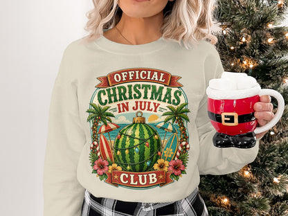Sweater with "Official Christmas in July Club" text and watermelon Christmas ornament.