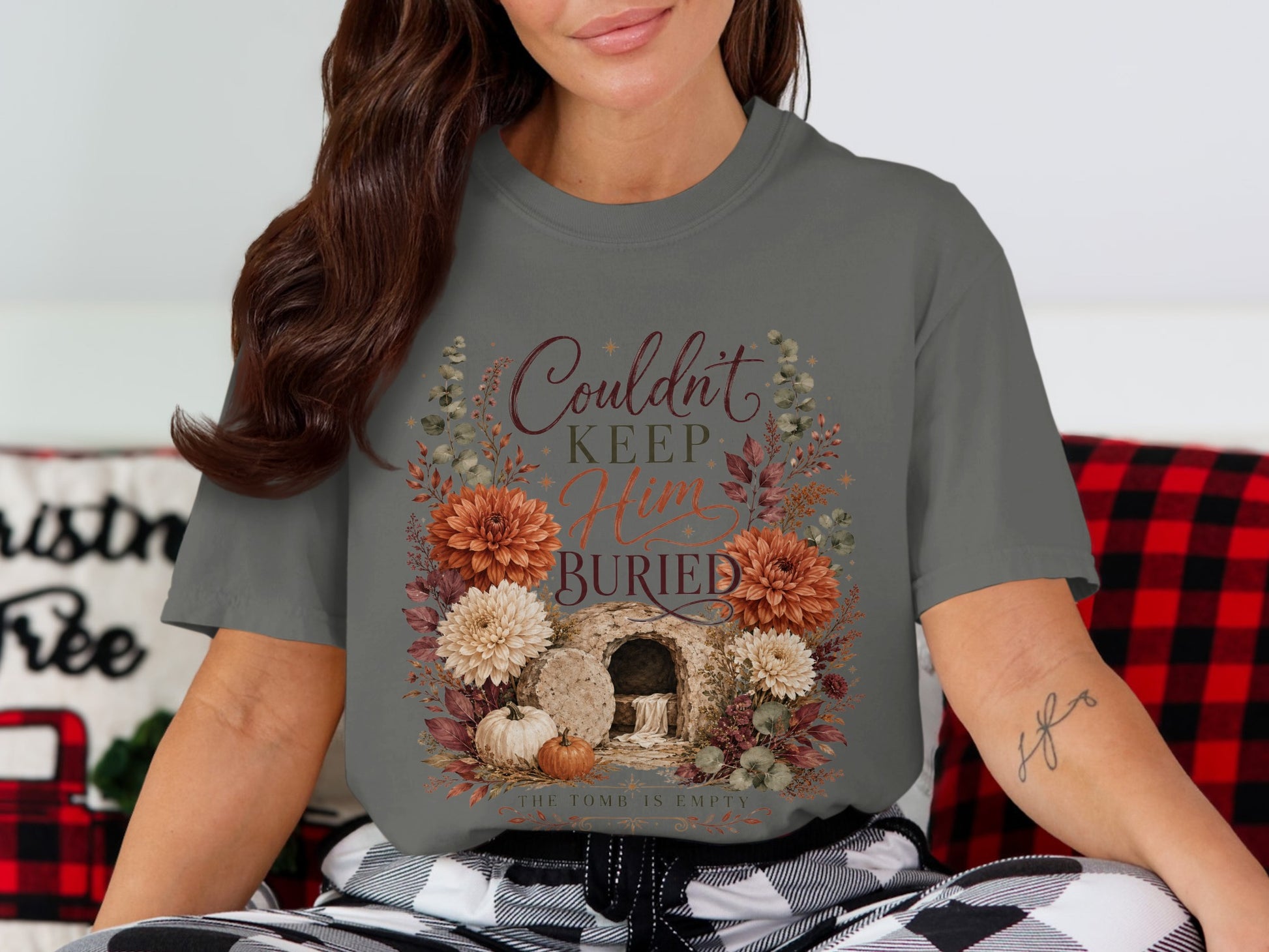 T-shirt graphic with "Couldn't Keep Him Buried" text and an open tomb.