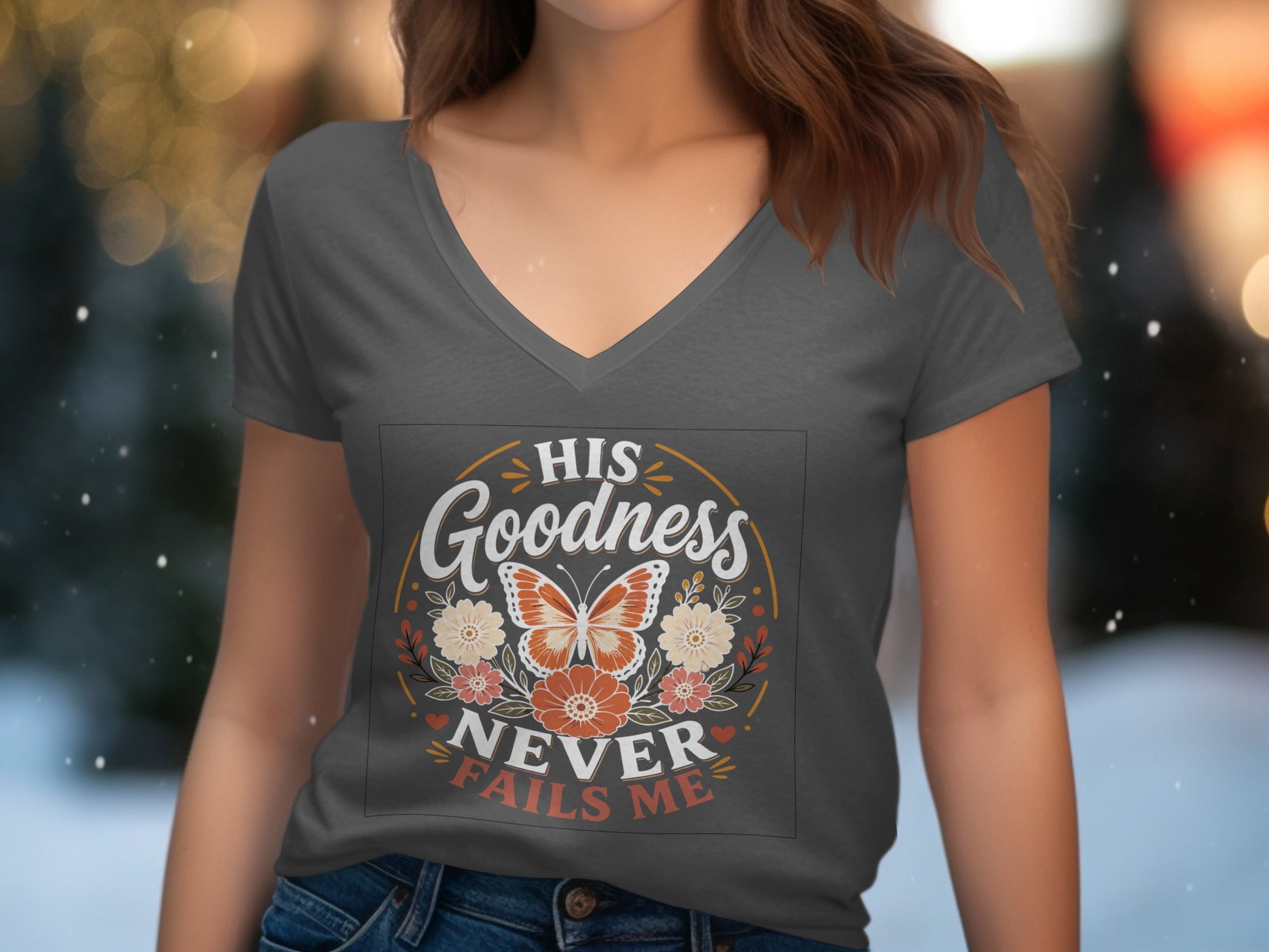 Dark grey t-shirt with "His Goodness Never Fails Me" text and butterfly graphic.