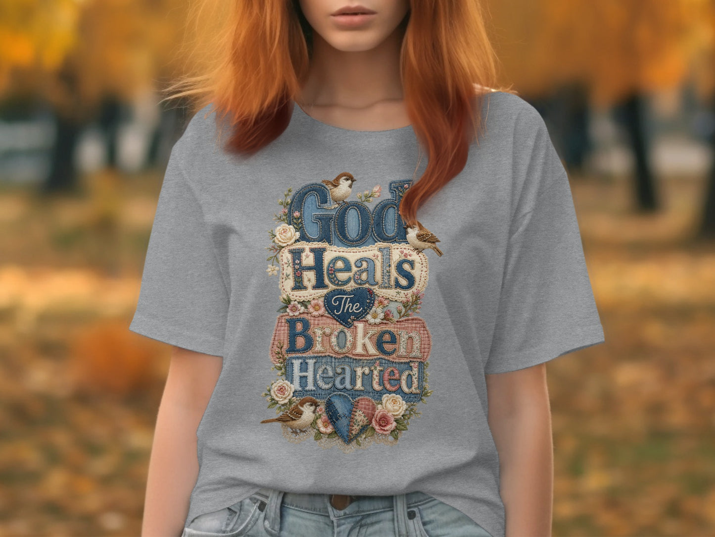 Grey t-shirt with "God Heals The Brokenhearted" text, birds, and floral accents.