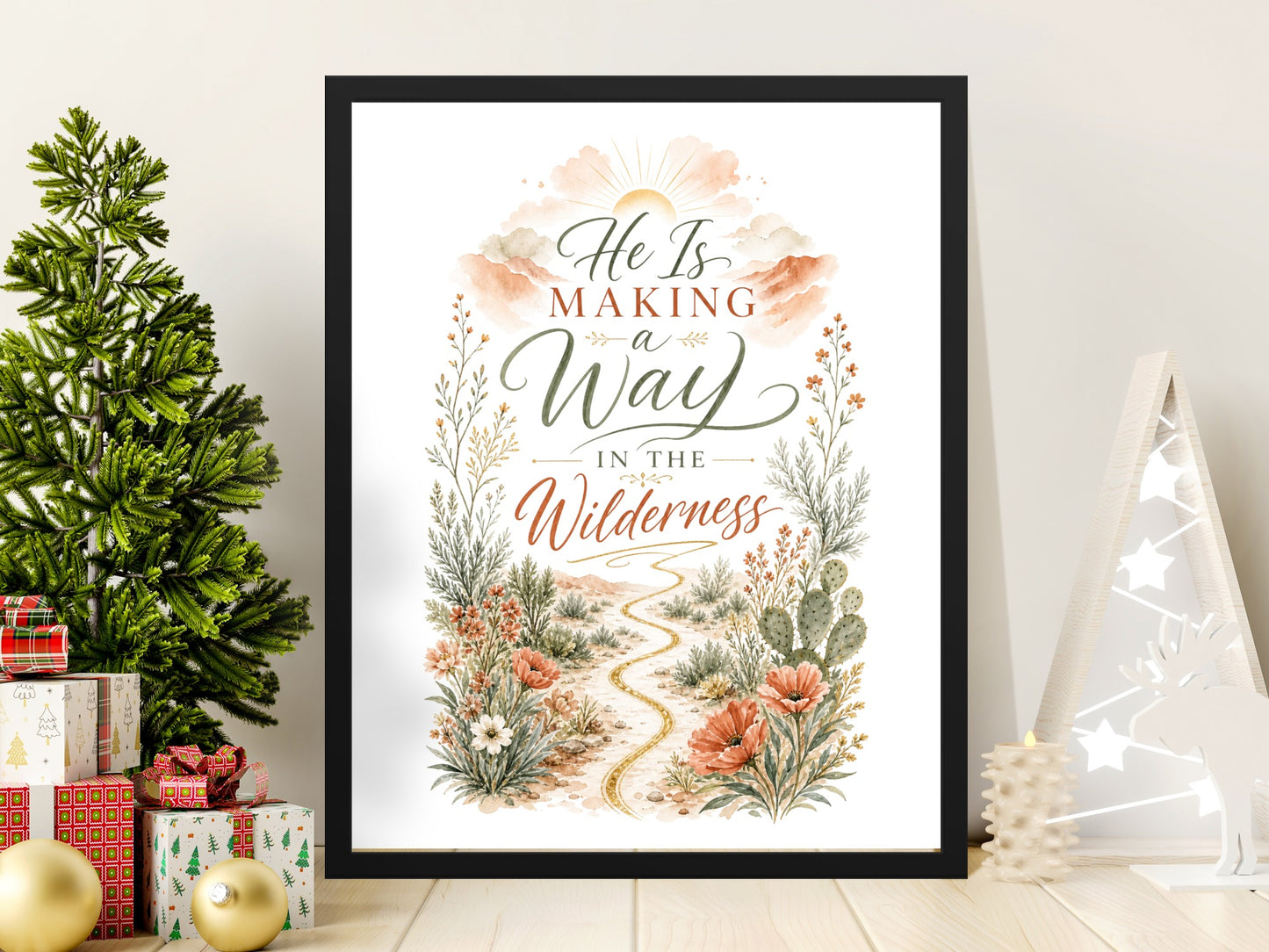 Framed artwork with text "He Is Making a Way In The Wilderness" and desert wildflowers.