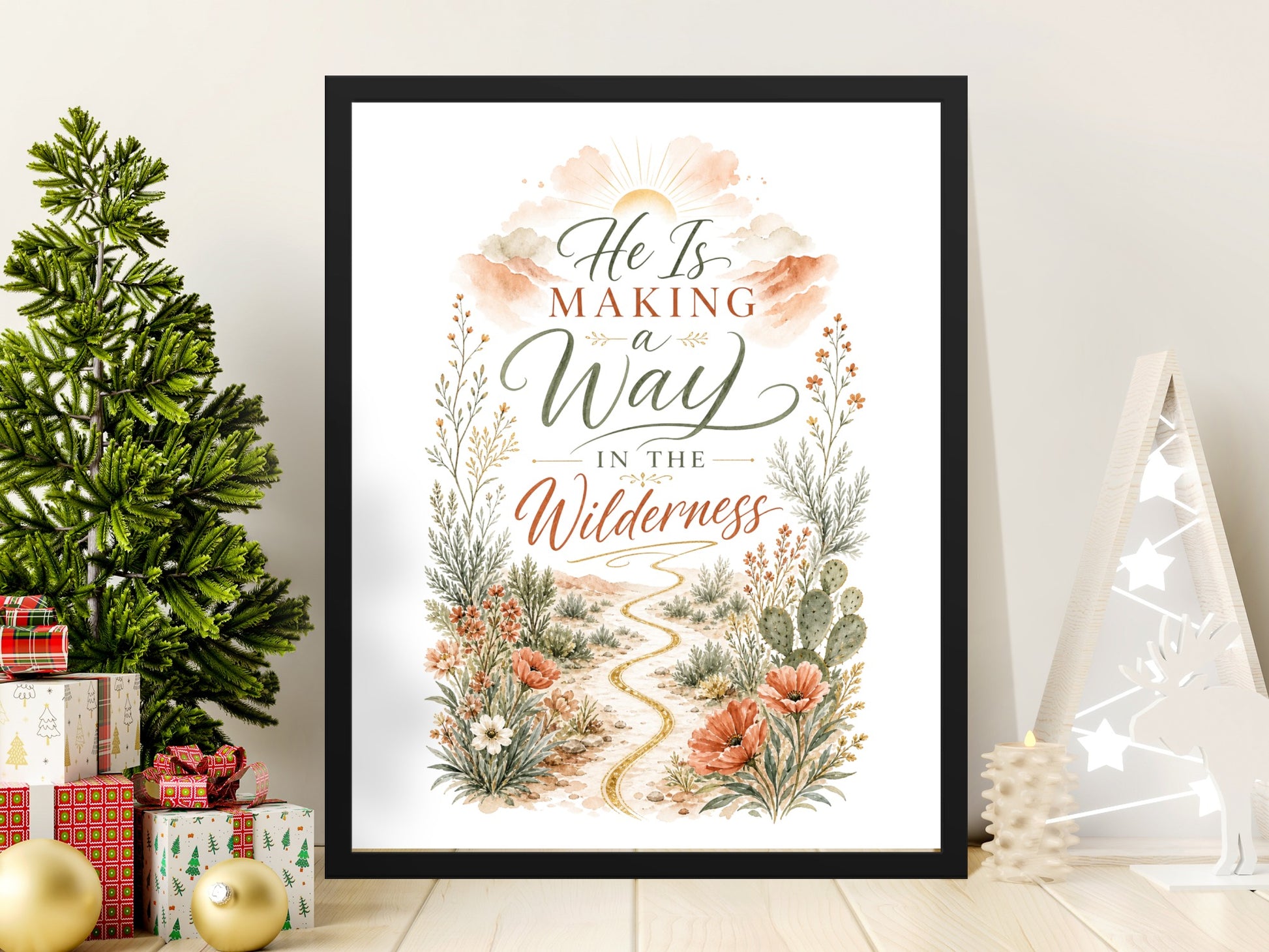Framed artwork with text "He Is Making a Way In The Wilderness" and desert wildflowers.
