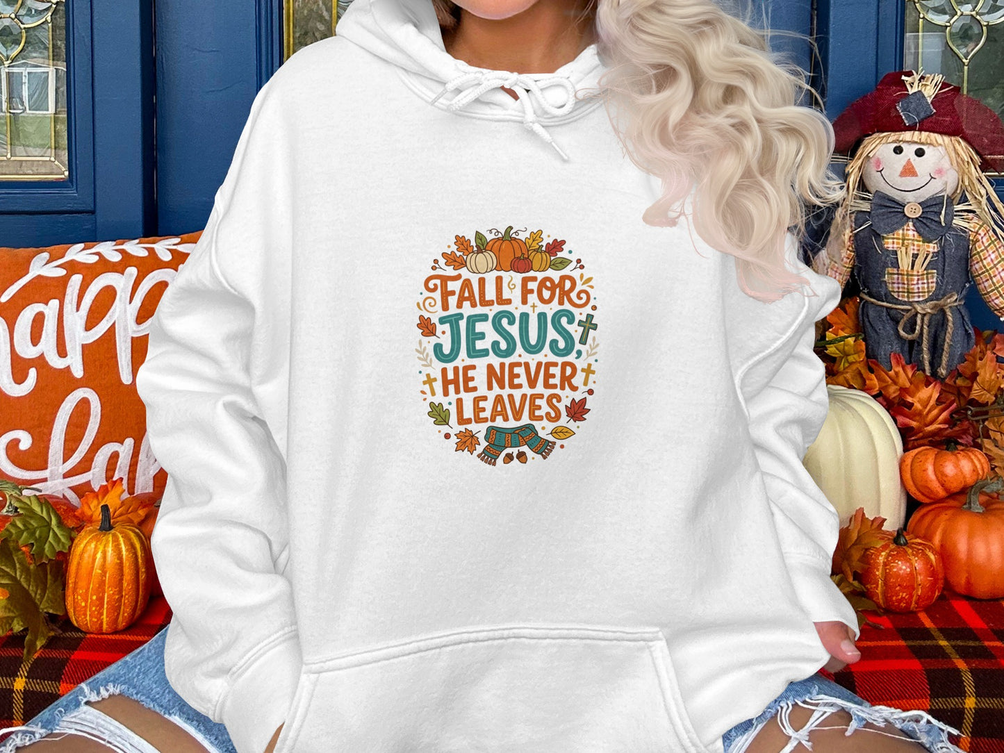 White hoodie with "Fall For Jesus He Never Leaves" text and autumn leaves.