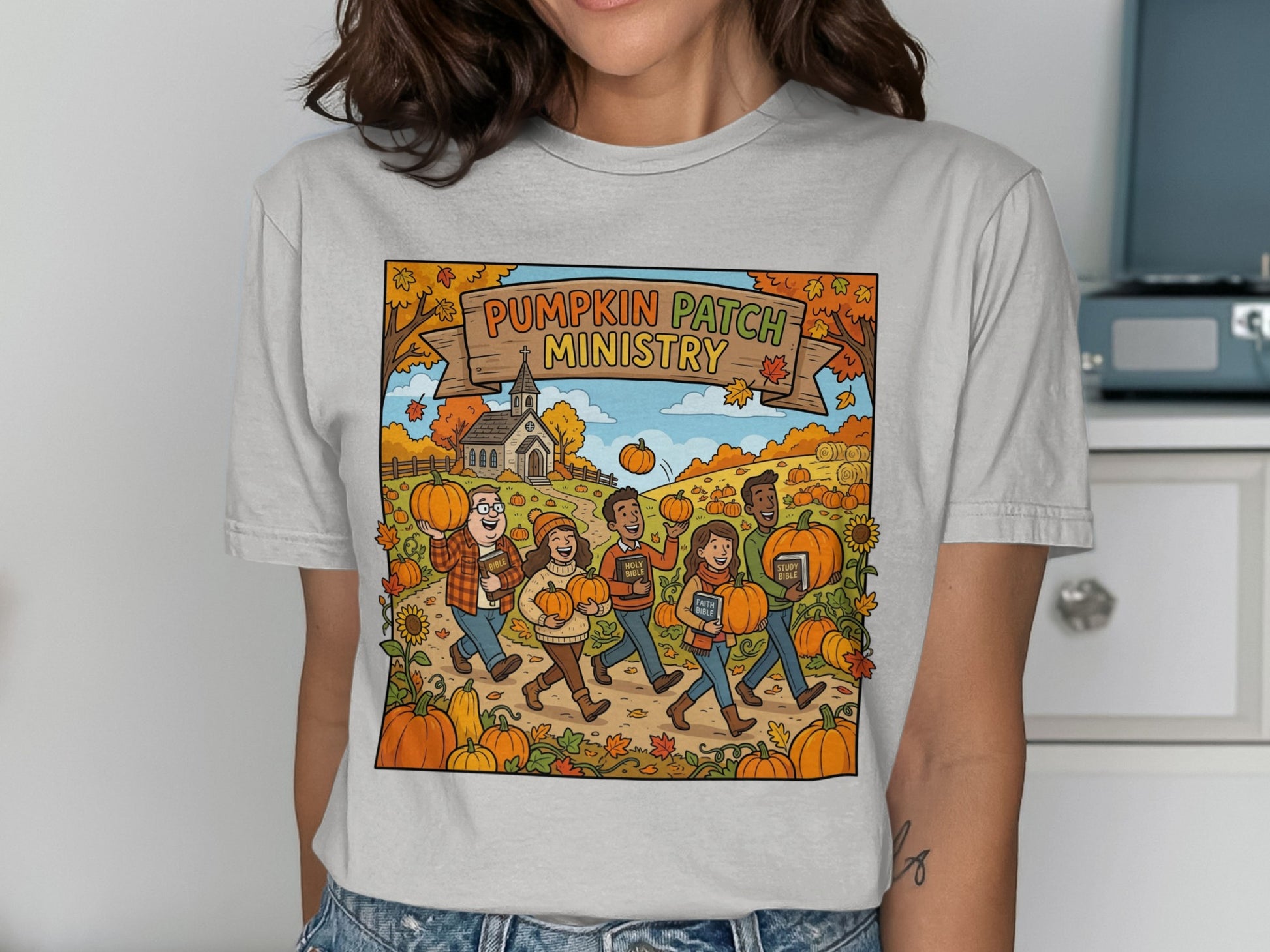 Pumpkin Patch Ministry text on t-shirt with cartoon people holding pumpkins.