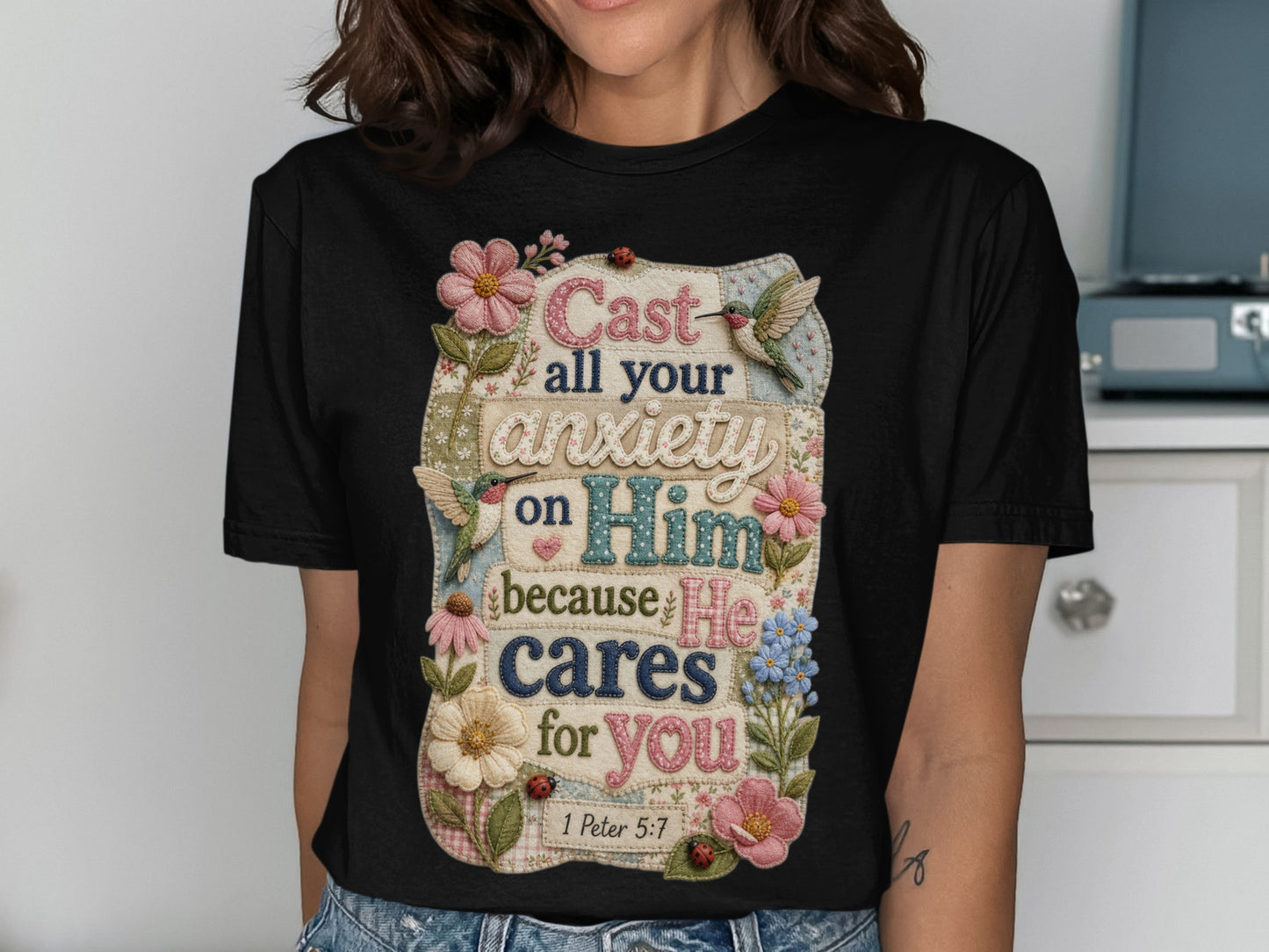 T-shirt with "Cast all your anxiety on Him because He cares for you 1 Peter 5:7" text and floral accents.