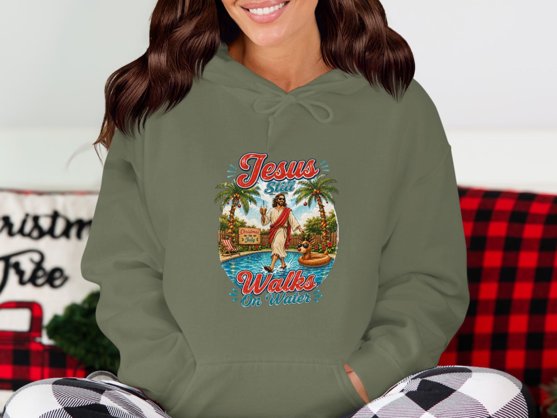 Hoodie with Jesus walking on water graphic, palm trees, pool, and text "Jesus Walks On Water".